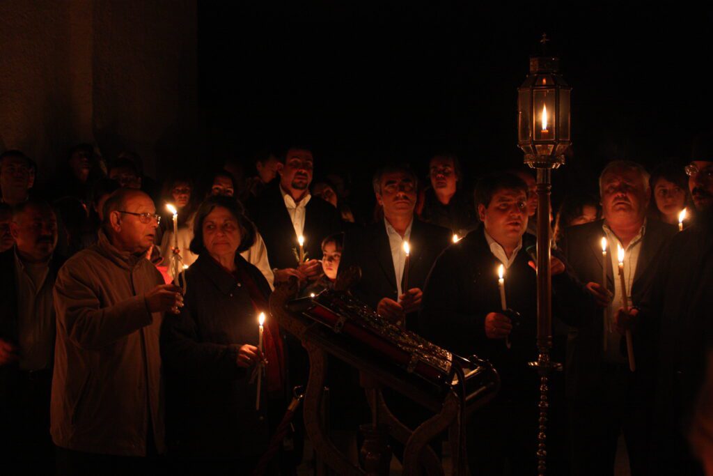 Ostern in Griechenland - Menschen mit Kerzen vor einer orthodoxen Kirche bei Nacht